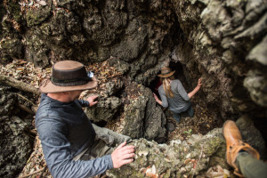 Amber and David climbing down into the lava tubes, Chyulu Hills, Kenya