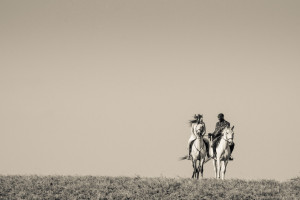 Amber makes her wedding entrance on horseback, with a Maasai rider at her side