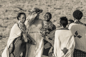 Maasai women walk Amber down the aisle, singing and dancing
