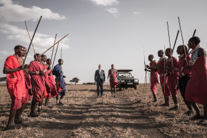 Maasai warriors form a line with their spears, welcoming David to the marriage site